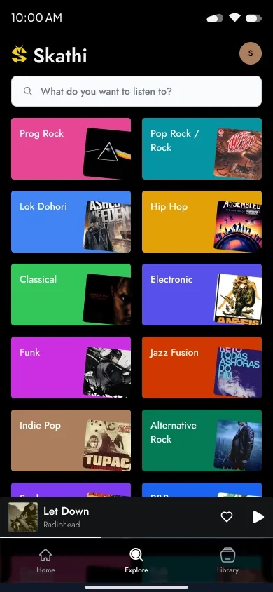 Explore tab with a full-bleed colour grid of genres over album art crops.